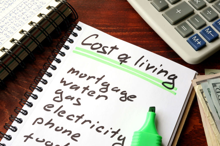 Notebook with a list of cost of living items and bills