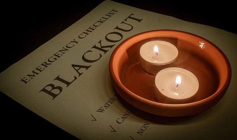 checklist with two lit tea candles