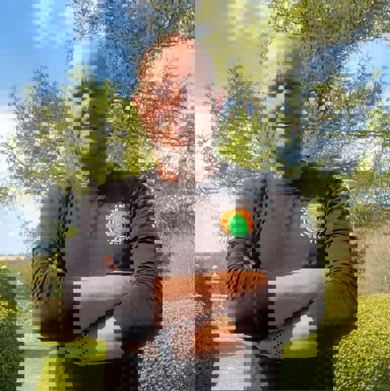 man standing outside with arms crossed