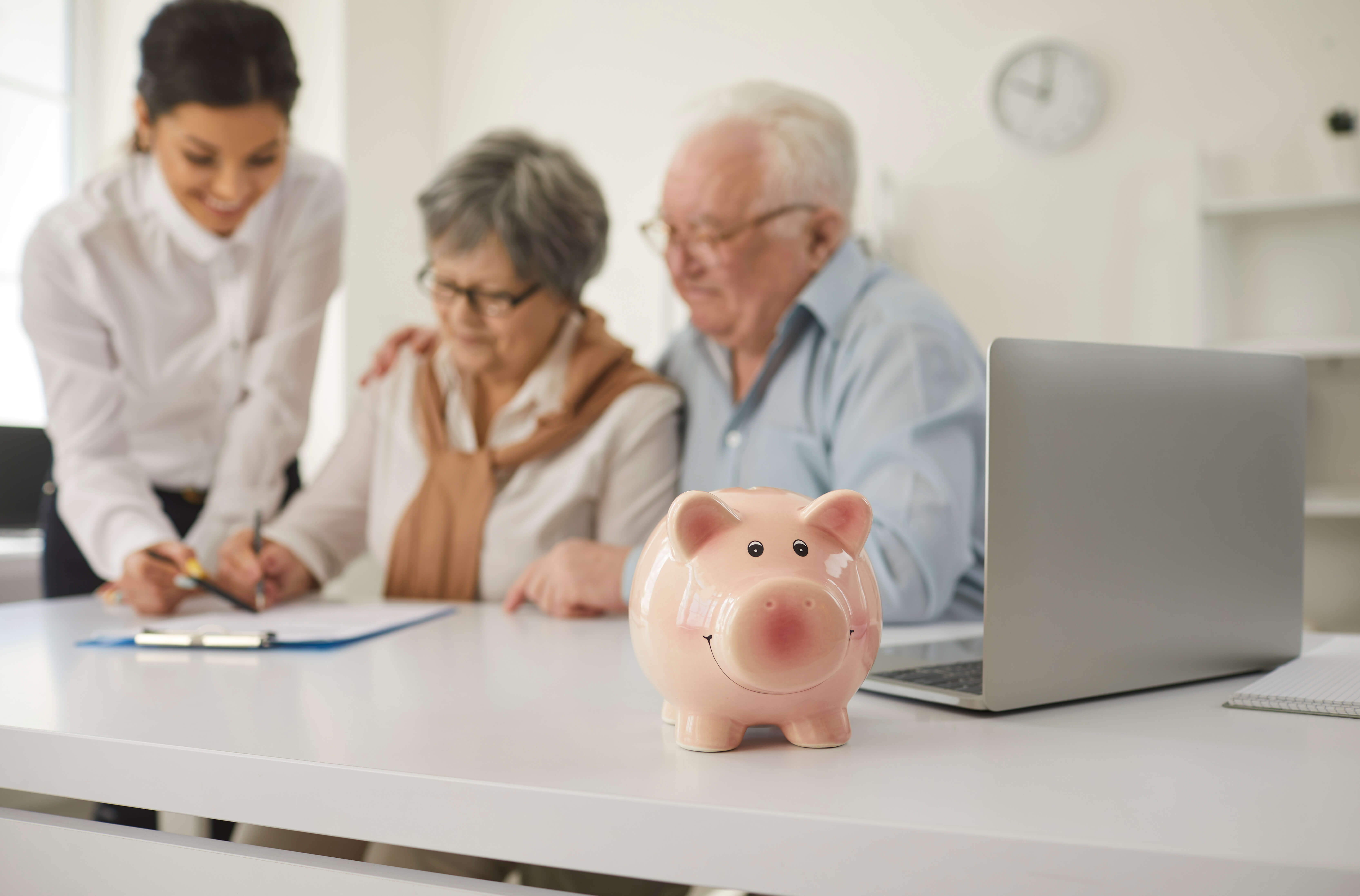 elderly couple sitting at a table getting financial advice
