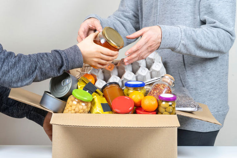 person passing a tin to another person