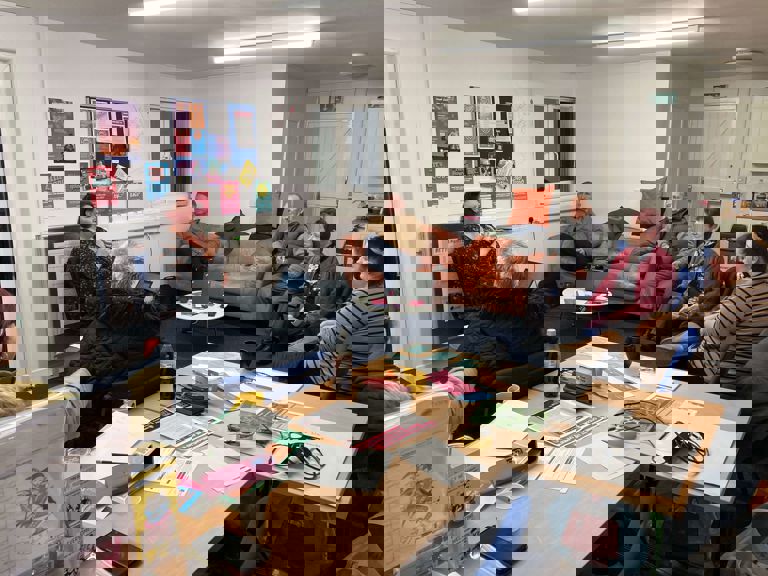 people sitting in a circle in a lounge talking