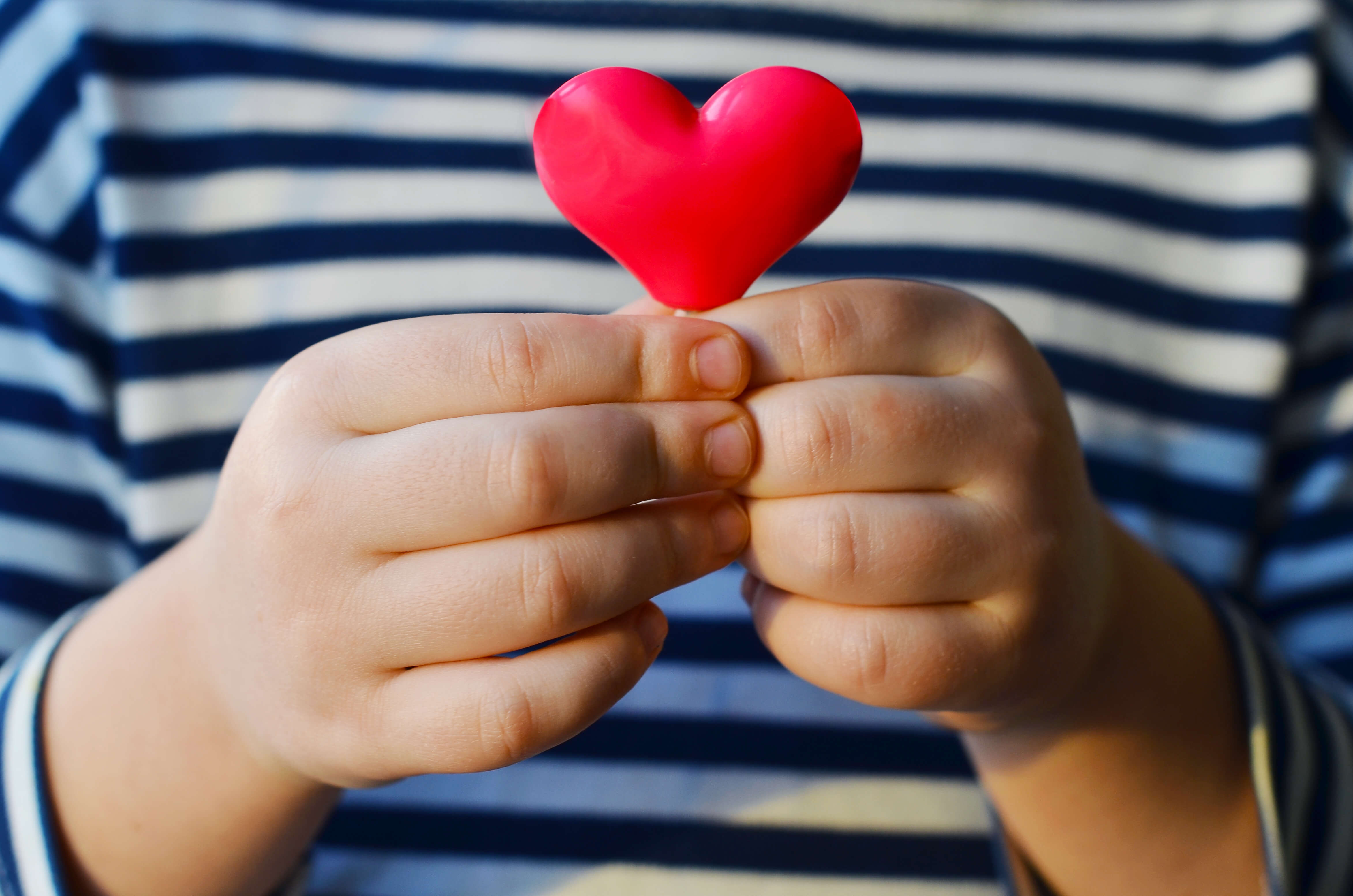 child in striped shirt holding a chart