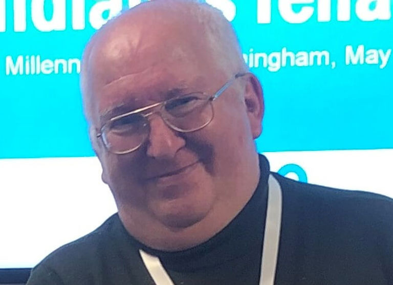 John smiling wearing a black shirt